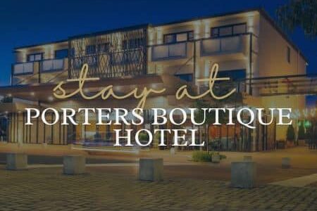 Things to Do in Hawke's Bay | Stay at Porters Boutique Hotel - Text over lit up hotel facade.